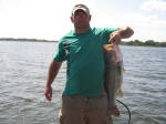 Jason with a bass caught while fishing with Pro Guide Eddie Garr