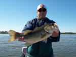 Ozzy with a bass caught while fishing with Pro Guide Eddie Garrett