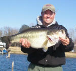 Lake Fork Pro Guide Tom Redington with a 12.3 lb'er caught 2/4/06, on a jig and craw.  In one cast it went from cold and windy to smokin' hot on Lake Fork.
