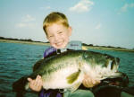 Pro Guide Jimmy Everett's son Nathan, age 4, with an 8lb bass. The smile tells it all.