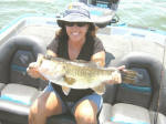 Candi England with a nice bass caught while fishing with  Pro Guide Marc Mitchell.